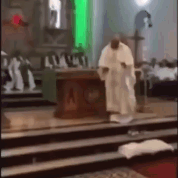 A Man In A White Robe Is Standing In Front Of A Church Altar . GIF