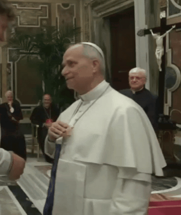 A Man In A White Robe Is Talking To Another Man GIF