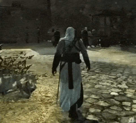 a man in a white robe is walking down a cobblestone street in a video game