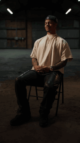 Man In White Shirt And Black Hat Sitting GIF