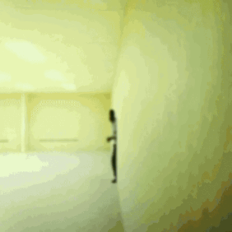 A Man In A White Shirt And Black Pants Is Running In A Room GIF