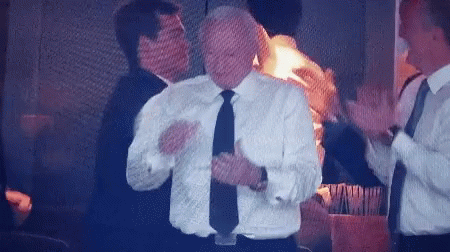 A Man In A White Shirt And Black Tie Applauds GIF