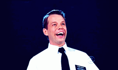 A Man In A White Shirt And Black Tie Has A Name Tag On His Chest That Says Brian Wright GIF