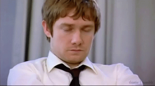 A Man In A White Shirt And Black Tie Is Sleeping With His Eyes Closed . GIF