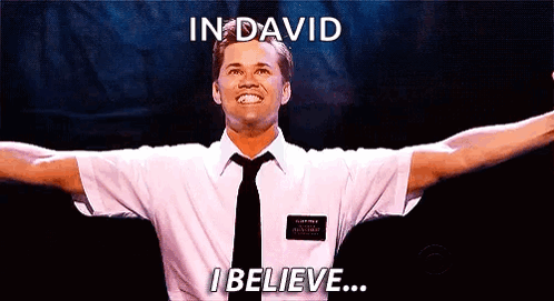 A Man In A White Shirt And Black Tie Is Standing With His Arms Outstretched And Says In David I Believe .. GIF