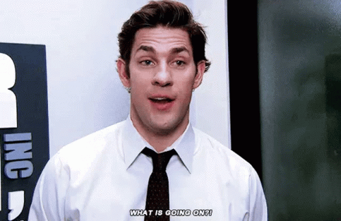 A Man In A White Shirt And Black Tie Is Talking About What Is Going On . GIF