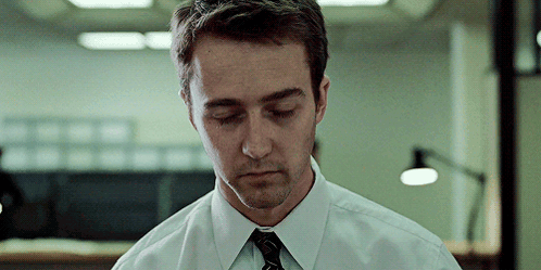 A Man In A White Shirt And Black Tie Looks Down With His Eyes Closed GIF
