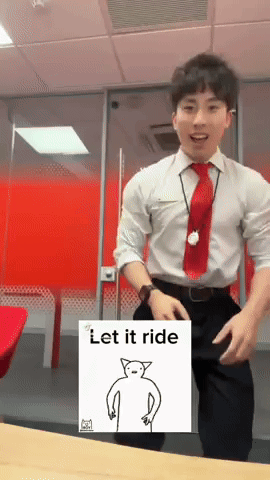 a man in a white shirt and red tie is dancing in front of a sign that says " let it ride "