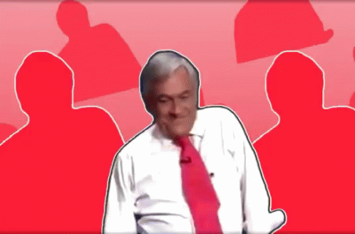A Man In A White Shirt And Red Tie Stands In Front Of A Red Background GIF