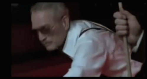 A Man In A White Shirt And Suspenders Is Holding A Rope . GIF
