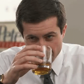 A Man In A White Shirt And Tie Drinks A Glass Of Whiskey GIF