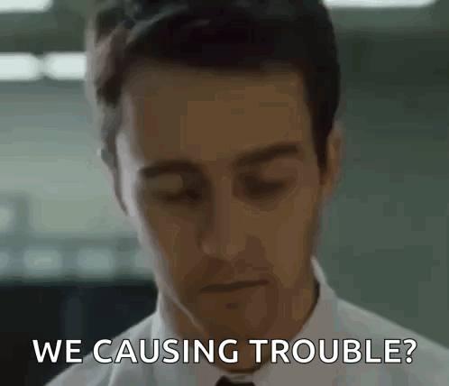 a man in a white shirt and tie is asking if he is causing trouble