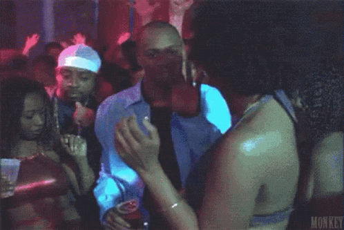 A Man In A White Shirt And Tie Is Dancing In A Club Holding A Cup Of Beer . GIF