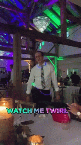 A Man In A White Shirt And Tie Is Dancing In A Room With The Words Watch Me Twirl On The Bottom GIF