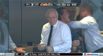 A Man In A White Shirt And Tie Is Dancing In Front Of A Screen That Says Nfl Cubs GIF