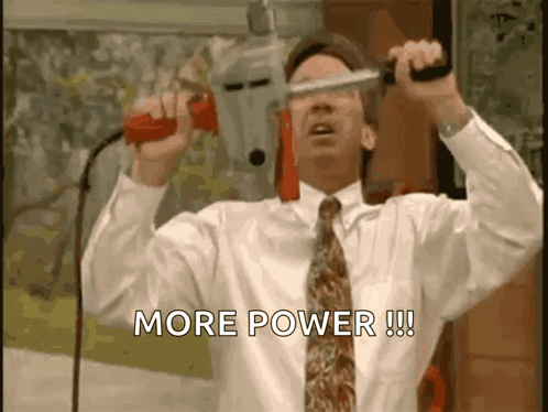 A Man In A White Shirt And Tie Is Holding A Drill And Says More Power GIF