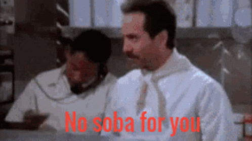 A Man In A White Shirt And Tie Is Sitting At A Desk And Says No Soba For You GIF