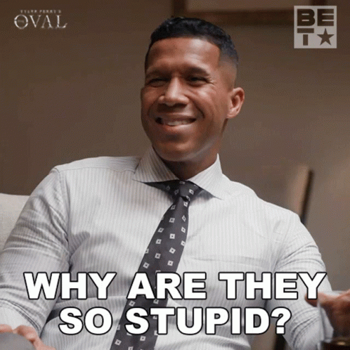 A Man In A White Shirt And Tie Is Smiling And Says Why Are They So Stupid GIF