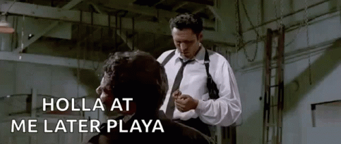 A Man In A White Shirt And Tie Is Standing Next To Another Man In A Room . GIF