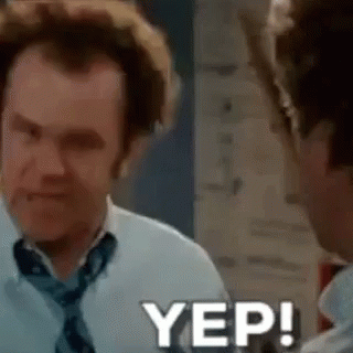 A Man In A White Shirt And Tie Is Talking To Another Man In A Room . GIF