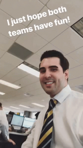 a man in a white shirt and tie smiles with the words i just hope both teams have fun below him