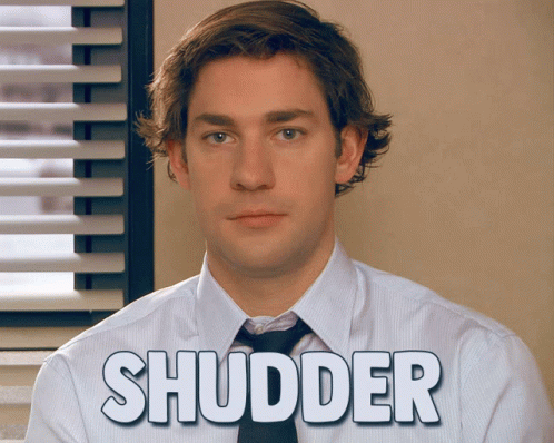 A Man In A White Shirt And Tie With The Word Shudder Written On His Shirt GIF