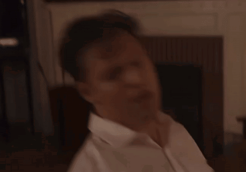 A Man In A White Shirt Holds A Microphone In His Hand GIF