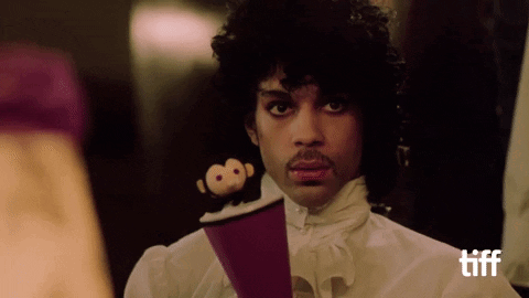 A Man In A White Shirt Holds A Stuffed Monkey On A Purple Object GIF