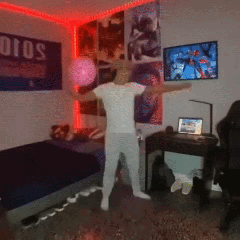 A Man In A White Shirt Is Dancing In A Bedroom With Posters On The Wall . GIF