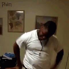 A Man In A White Shirt Is Dancing In A Room With The Name Philm Written On The Wall GIF