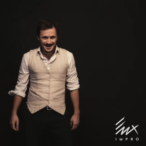 a man in a white shirt is dancing in front of a black background with the word impro on it