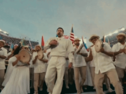 A Man In A White Shirt Is Dancing In Front Of A Crowd GIF