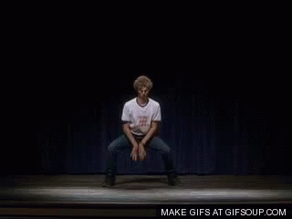 A Man In A White Shirt Is Dancing On A Stage GIF