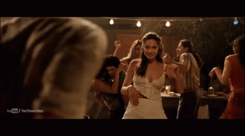 a man in a white shirt is dancing with a woman in a dark room with a youtube logo on the bottom