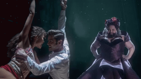 A Man In A White Shirt Is Dancing With Two Women GIF