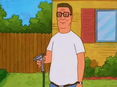 A Man In A White Shirt Is Holding A Hose In His Hand In Front Of A House . GIF