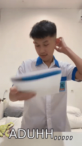 A Man In A White Shirt Is Holding A Piece Of Paper With The Word Aduh Written On The Bottom GIF