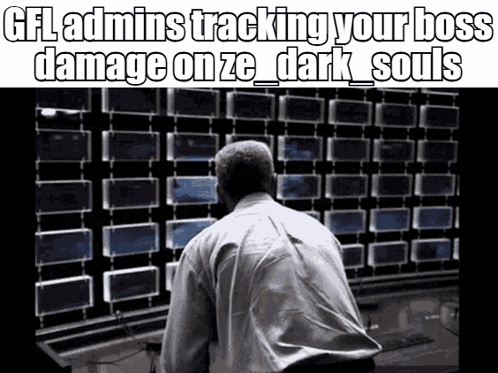 A Man In A White Shirt Is Looking At A Wall Of Monitors . GIF