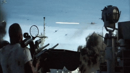 a man in a white shirt is looking through a telescope at a plane flying in the sky