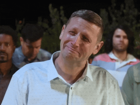 A Man In A White Shirt Is Making A Face GIF