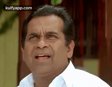 A Man In A White Shirt Is Making A Funny Face And Making A Funny Face . GIF