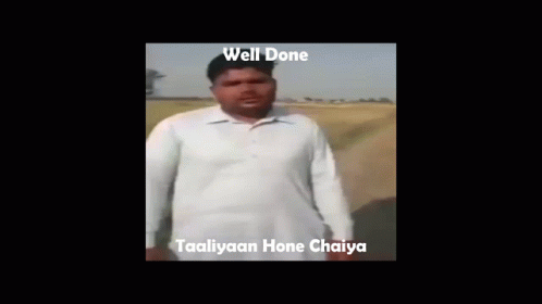 A Man In A White Shirt Is Making A Funny Face With The Words Well Done Taaliyaan Hone Chaiya Below Him GIF