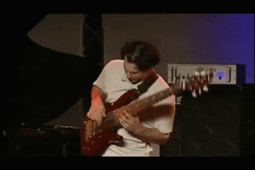 A Man In A White Shirt Is Playing A Guitar In Front Of A Yamaha Amplifier GIF