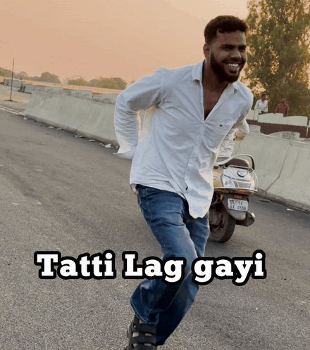 A Man In A White Shirt Is Running Down The Road With The Words Tatti Lag Gayi Written Below Him GIF