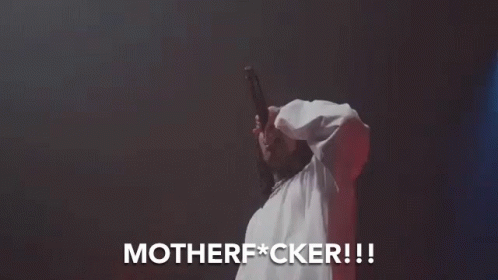 A Man In A White Shirt Is Singing Into A Microphone And The Words Motherfucker Are Above Him GIF