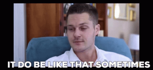 A Man In A White Shirt Is Sitting In A Chair With The Words `` It Do Be Like That Sometimes '' Written Above Him . GIF