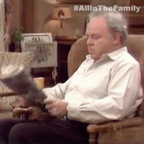 Man In White Shirt Reading Book In Rocking Chair GIF