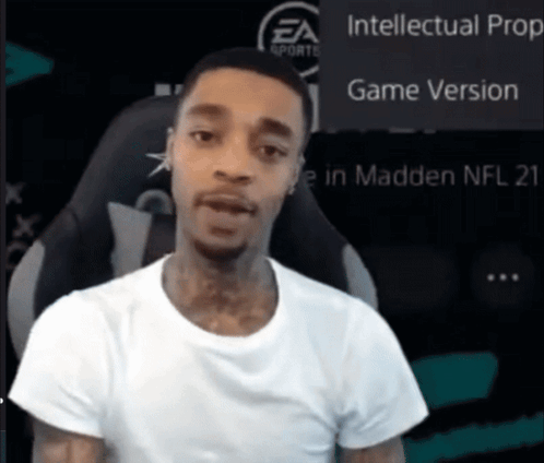 A Man In A White Shirt Is Sitting In Front Of A Screen That Says Intellectual Prop Game Version GIF