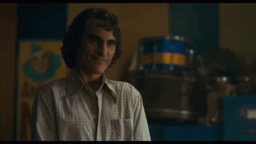 Man Smiling In White Shirt In Front Of Drum GIF