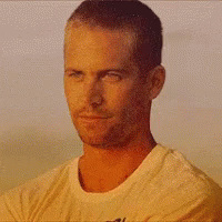 A Man In A White Shirt Is Smiling With His Eyes Closed And His Mouth Open . GIF